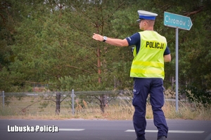 Policjant wskazuje kierującemu miejsce w którym ma się zatrzymać