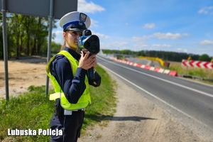policjantka trzyma urządzenie do pomiary prędkosci